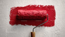 Red Paint Roller Applying Bright Red Color on Wall for Home Renovation