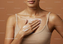 Close-up of Woman Applying Skincare Cream on Chest with Soft Background