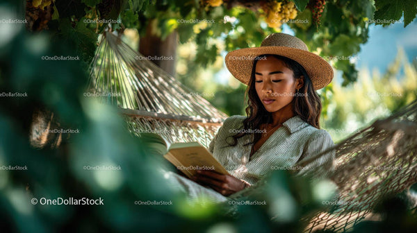Relaxed Woman Reading Book in Hammock Amid Lush Tropical Foliage