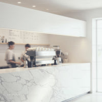Modern coffee bar with marble countertop and baristas