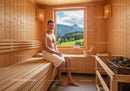 Relaxing Man in Wooden Sauna with Mountain View and Natural Light
