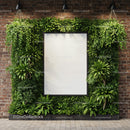 Vertical garden with blank frame on brick wall
