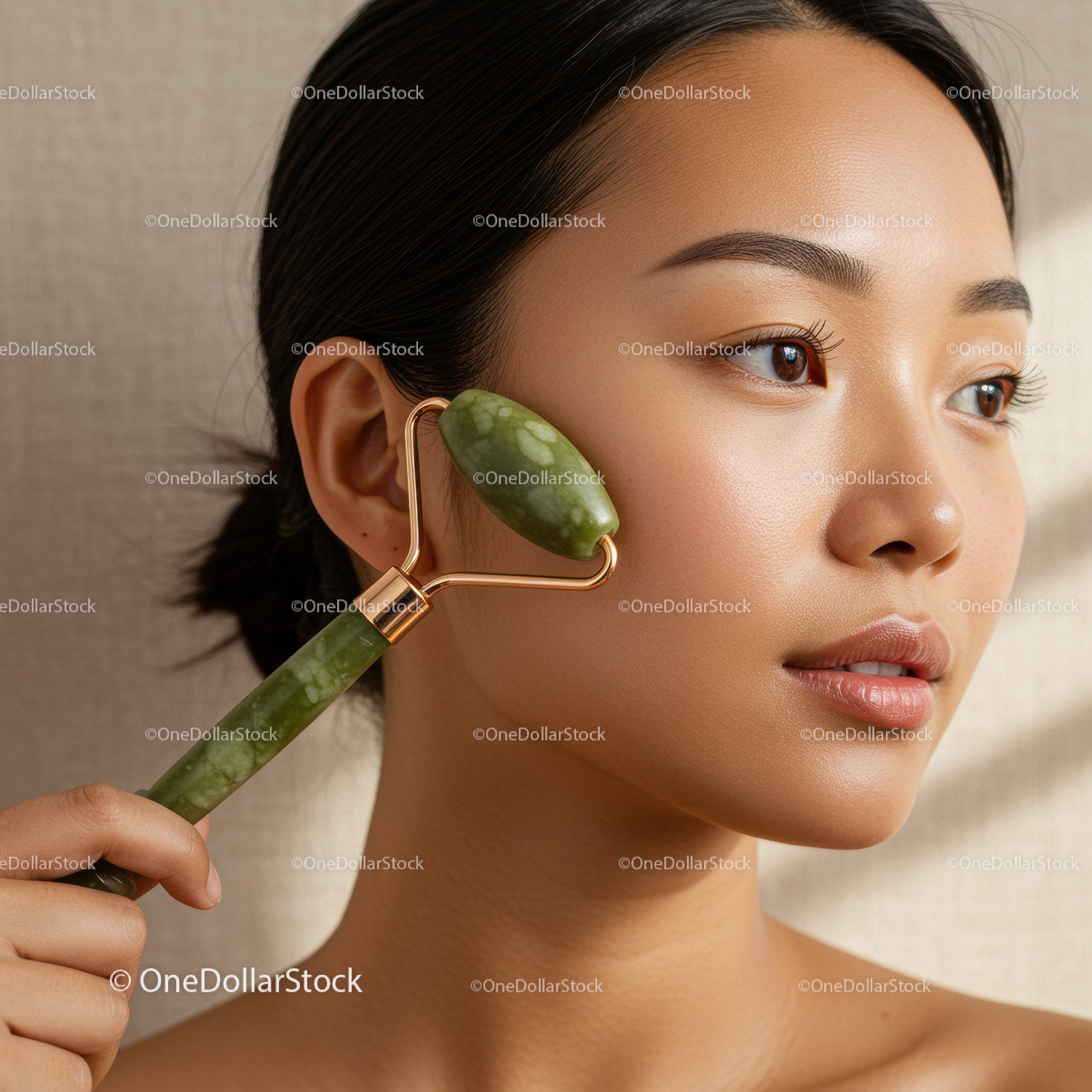 Elegant Woman Using Jade Roller for Facial Skin Care