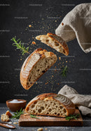 Freshly baked sourdough bread with herbs and crumbs