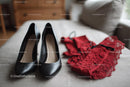 Chic Black Heels and a Red Lace Dress in a Cozy Bedroom Setting