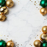 Gold and green Christmas baubles on marble surface