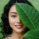 Joyful Woman with Large Green Leaves in Natural Environment