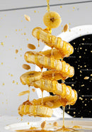 Banana slices dripping honey with scattered peanuts