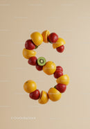 Fresh fruit arrangement forming number three on beige