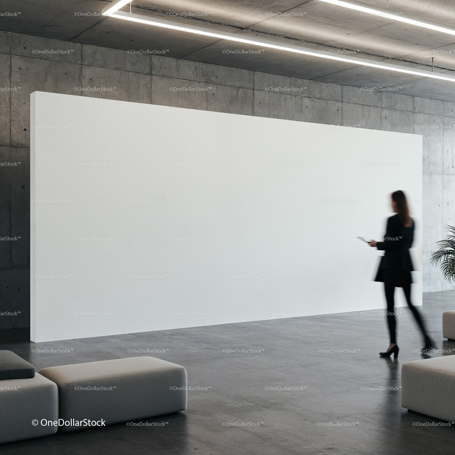 Woman walking past large blank white display in modern lobby