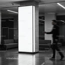 Blurred man walking past illuminated pillar in modern lobby
