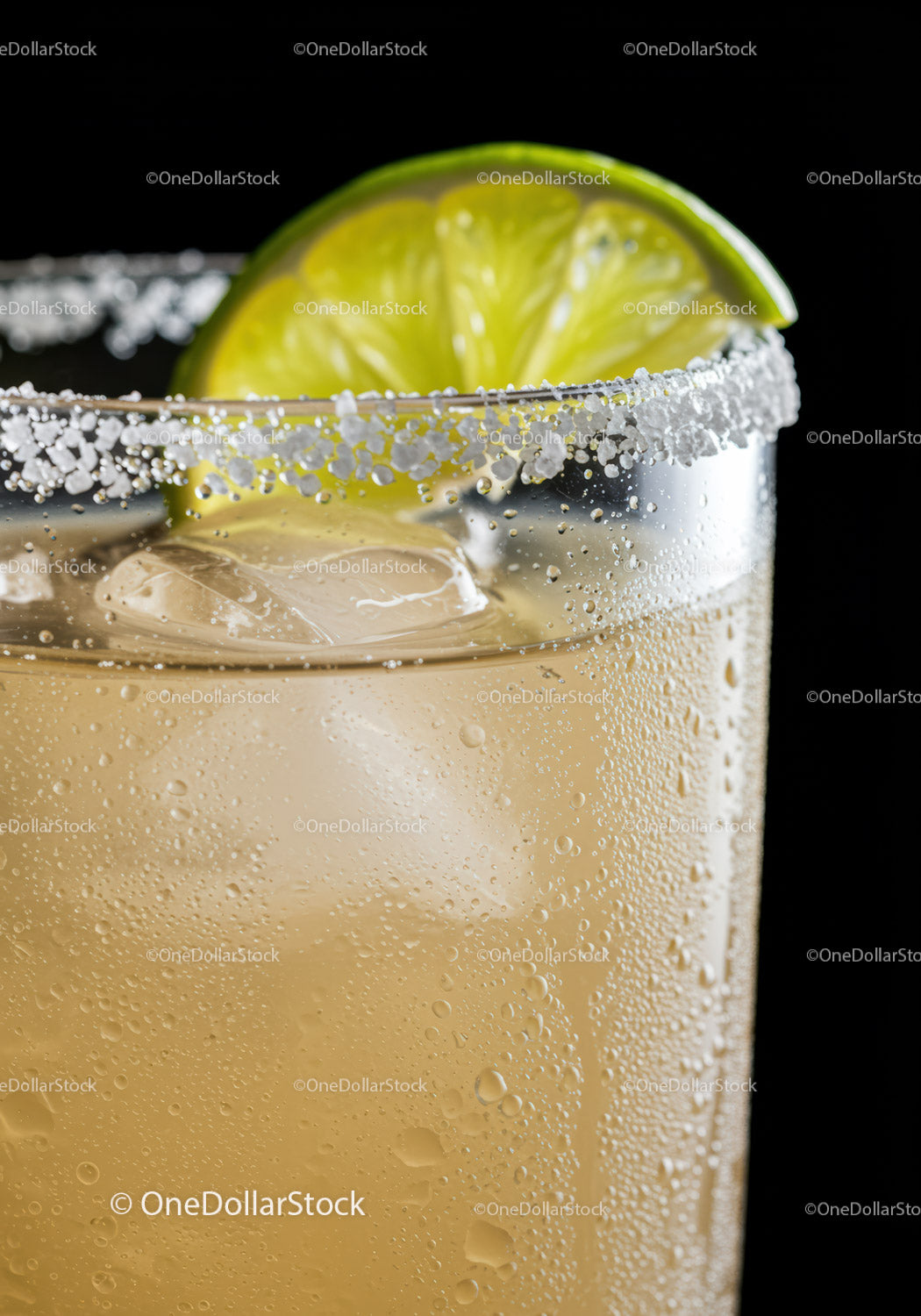 Refreshing iced cocktail with salted rim and lime wedge