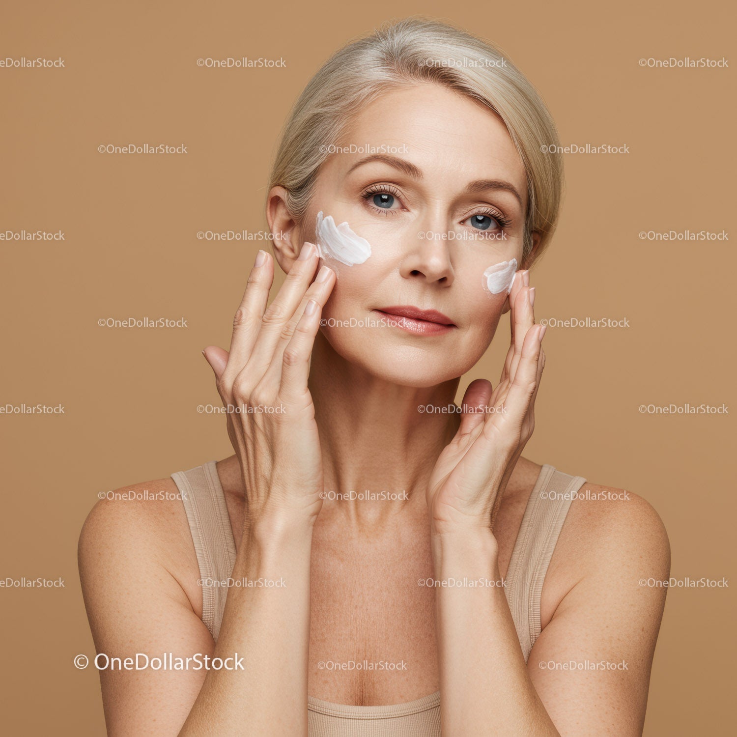 Elegant Mature Woman Applying Facial Cream for Skincare Routine