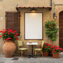 Cozy outdoor cafe table with vibrant red flowers