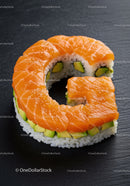 Fresh salmon sushi roll with avocado on black plate