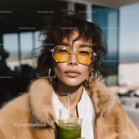 Fashionable Young Woman in Yellow Sunglasses Posing Outdoors on Sunny Day
