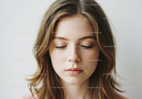 Serene Young Woman with Wavy Hair and Flawless Skin