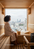 Woman Relaxing in Modern Sauna with City View in Cozy Wellness Space