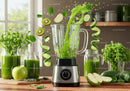 Fresh green smoothie ingredients splashing into blender