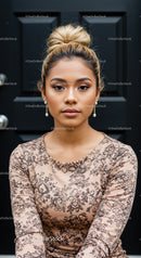 Young woman with floral dress and elegant pearl earrings