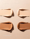 Varied Beige to Brown Foundation Swatches on Neutral Background