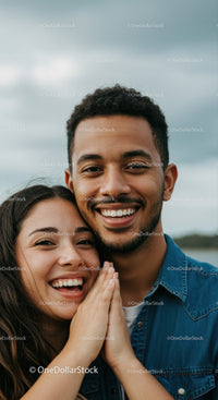 Happy couple embracing outdoors smiling warmly
