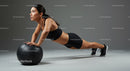 Fitness Woman Performing Push Ups with Medicine Ball in Stylish Gym