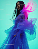 Stylish Woman in Flowing Blue Dress with Bright Colorful Background