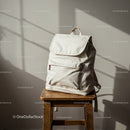 Minimalist beige backpack on wooden stool indoors