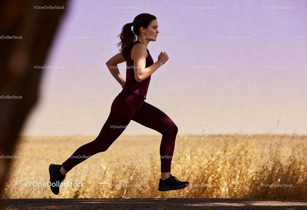 Focused woman running outdoors in serene natural setting