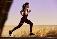 Focused woman running outdoors in serene natural setting