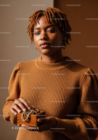 Stylish Woman in Beige Sweater Holding Jewelry Box with Pearls