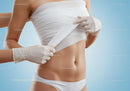 Close-Up of Woman Applying Bandage on Abdomen for Medical Care