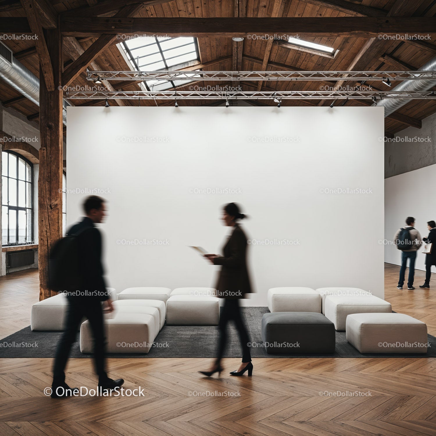 People walking in modern gallery with blank wall