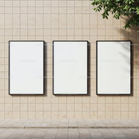 Three blank vertical posters on beige tiled wall