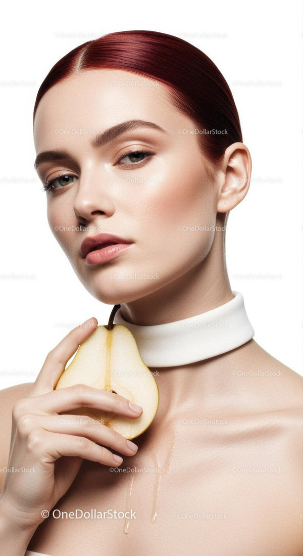 Elegant Woman with Red Hair Holding Pear in Studio