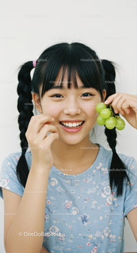 Smiling Girl Holding Fresh Green Grapes in Bright Casual Scene