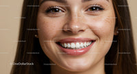Close-up of smiling woman with freckles and natural skin