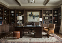 Elegant home office with classic wood bookshelves and leather chair