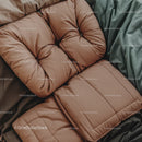 Beige Puffy Jacket Resting on Cushions for Cozy Winter Fashion