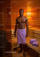 Healthy Young Man Relaxing in Spa Sauna with Towel in Wooden Interior
