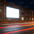 Blank Billboard on Brick Wall with Light Trails at Night