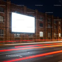Blank Billboard on Brick Wall with Light Trails at Night