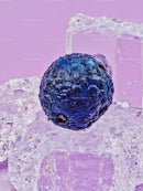Single Fresh Blueberry on Ice Cubes with Purple Background