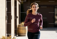 Focused woman jogging outdoors on a sunny day