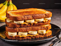 Banana and Peanut Butter Toast Sandwich on Black Plate