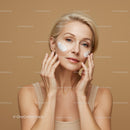 Elegant Mature Woman Applying Skincare Cream for Healthy Glowing Skin