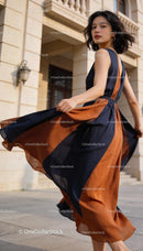 Elegant woman twirling in stylish color block dress