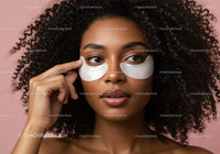 Young Woman Applying Under Eye Patches With Curly Hair