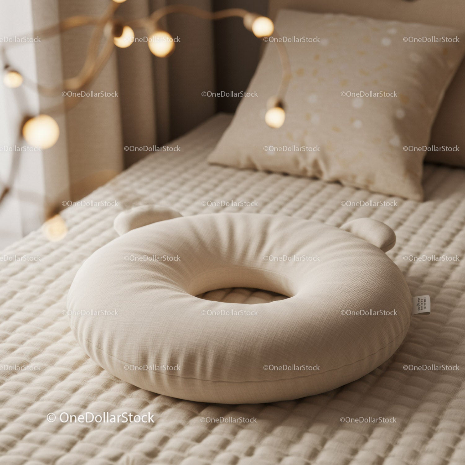 Soft beige baby support pillow on quilted bed